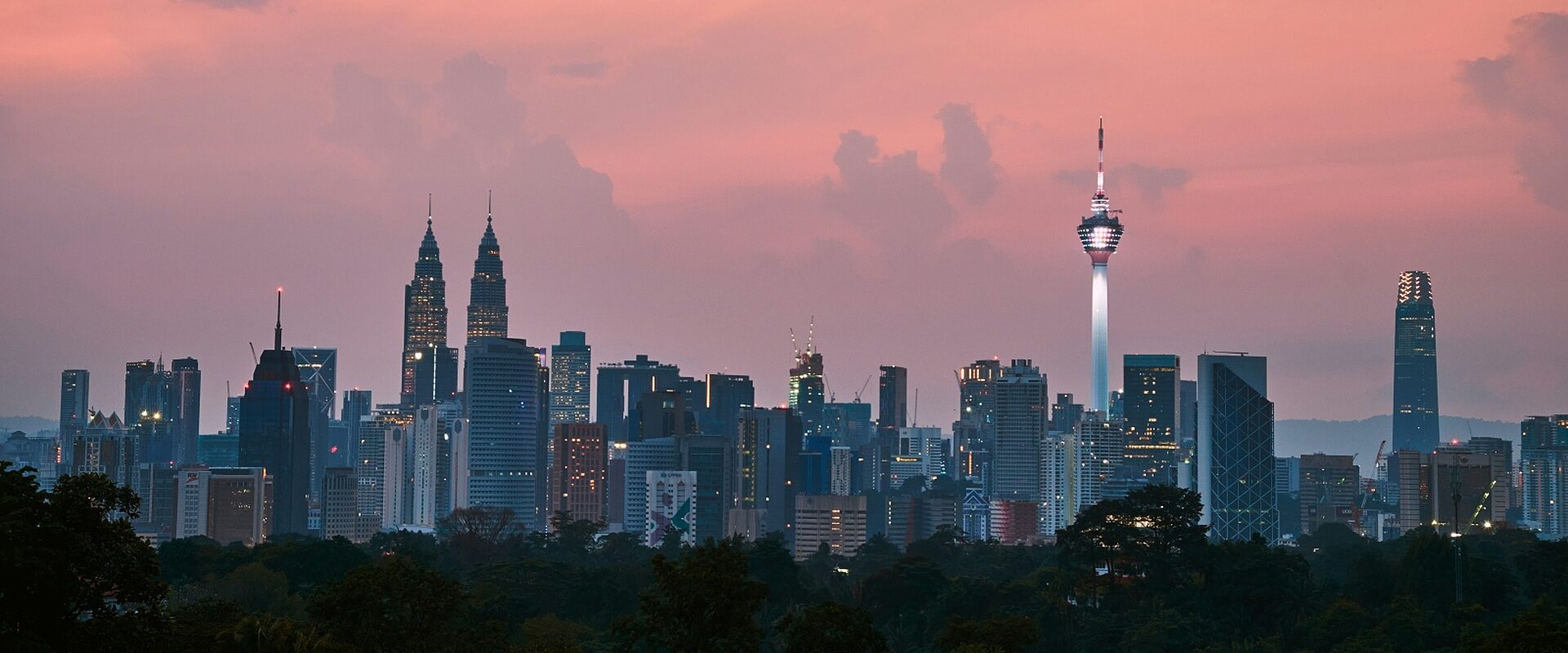 Kuala Lumpur skyline with the Petronas Twin Towers and KL Tower at sunset